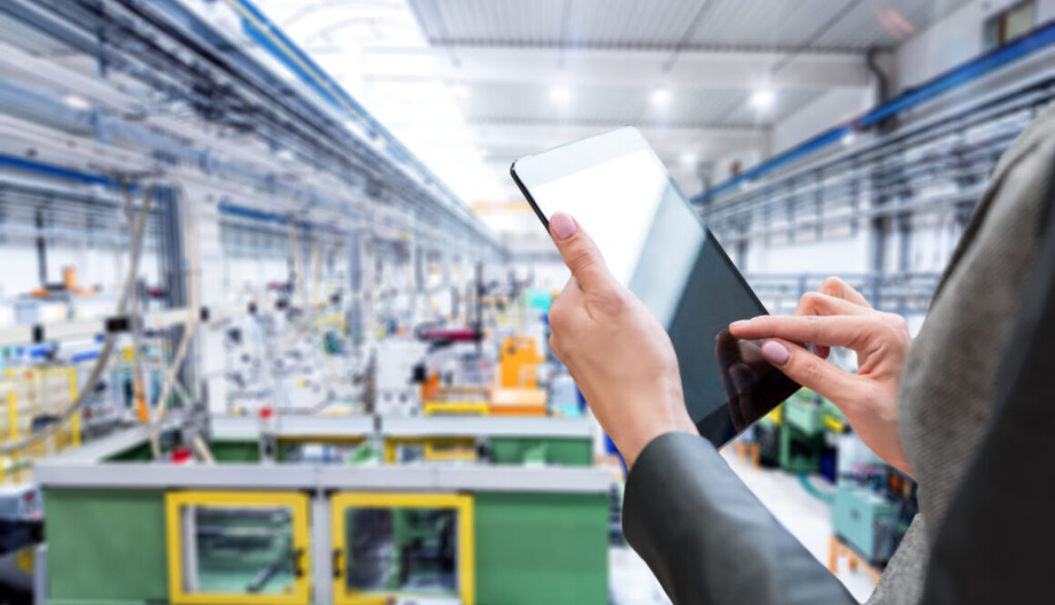 woman with ipad overseeing operations in warehouse