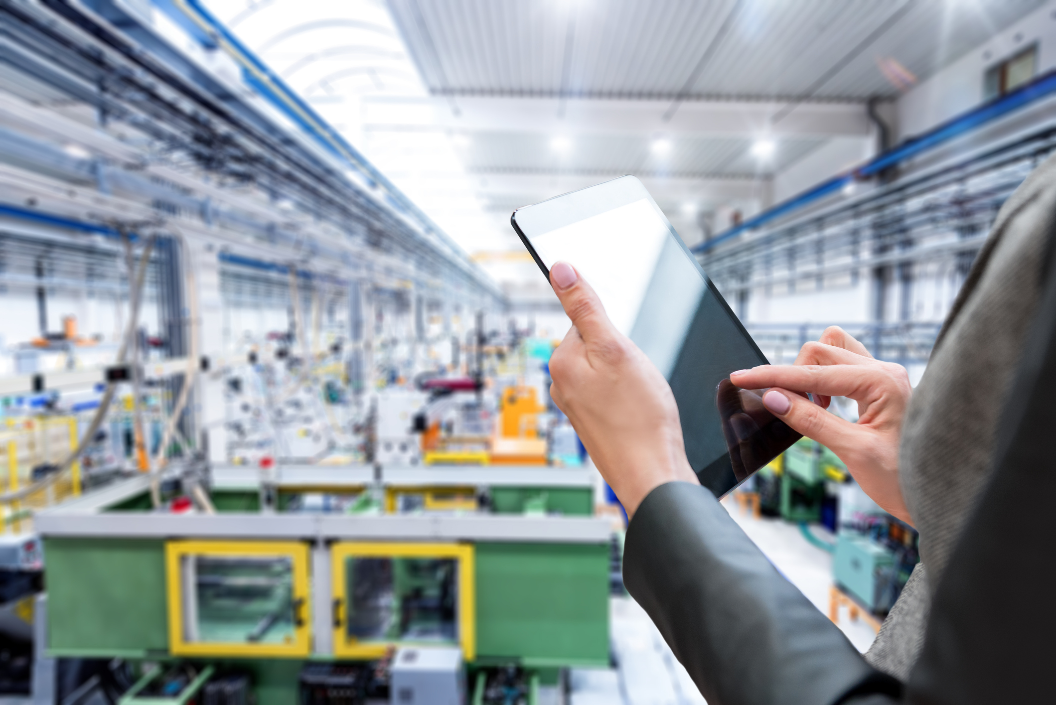 woman with ipad overseeing operations in warehouse